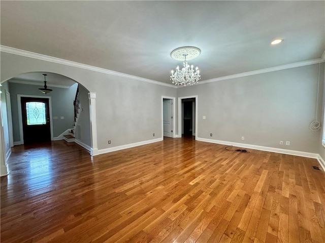 167 Techview Dr SW, Calhoun, GA 30701 - unfurnished room featuring a chandelier, arched walkways, wood finished floors, baseboards, and crown molding
