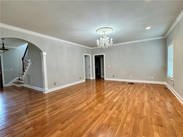 167 Techview Dr SW, Calhoun, GA 30701 - empty room featuring a chandelier, arched walkways, light wood-type flooring, stairway, and crown molding