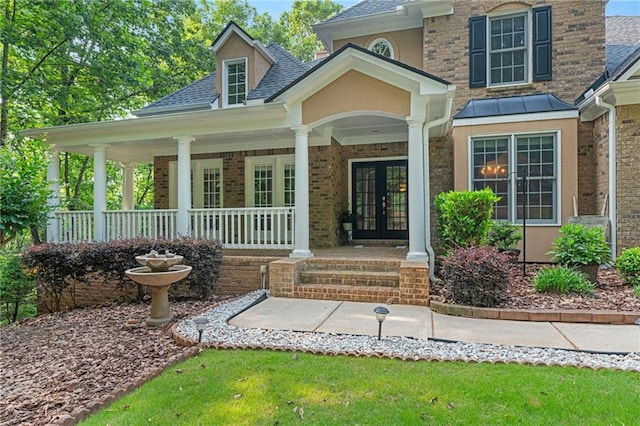 168 Eagle Pointe Dr, Dahlonega, GA 30533 - view of exterior entry featuring french doors, roof with shingles, covered porch, brick siding, and stucco siding