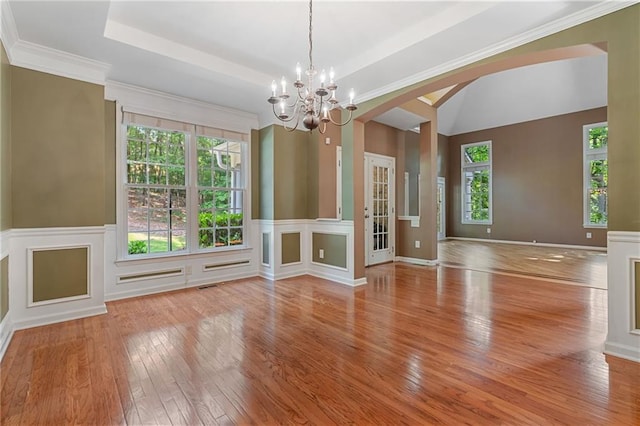 168 Eagle Pointe Dr, Dahlonega, GA 30533 - unfurnished dining area with hardwood / wood-style floors, plenty of natural light, arched walkways, a chandelier, and vaulted ceiling