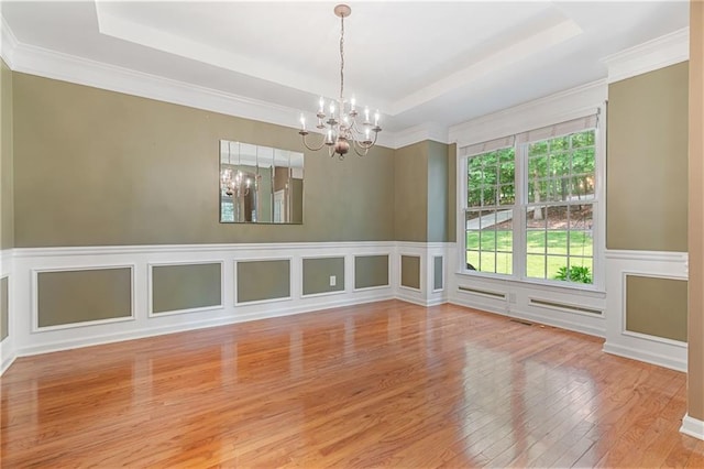 168 Eagle Pointe Dr, Dahlonega, GA 30533 - spare room featuring a chandelier, a tray ceiling, wood finished floors, crown molding, and a decorative wall
