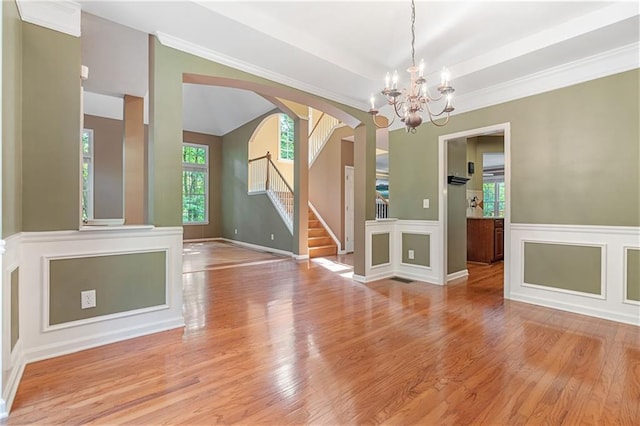 168 Eagle Pointe Dr, Dahlonega, GA 30533 - empty room featuring a chandelier, light wood-type flooring, stairway, and arched walkways