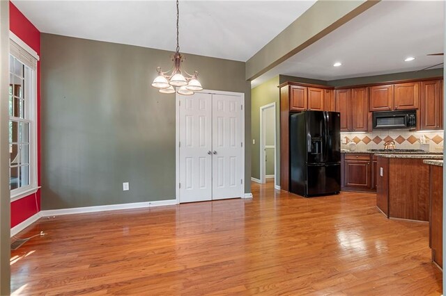 168 Eagle Pointe Dr, Dahlonega, GA 30533 - kitchen featuring black appliances, a chandelier, light wood finished floors, backsplash, and pendant lighting