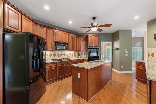 168 Eagle Pointe Dr, Dahlonega, GA 30533 - kitchen featuring black appliances, a ceiling fan, decorative backsplash, a sink, and light wood finished floors