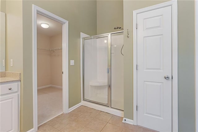 168 Eagle Pointe Dr, Dahlonega, GA 30533 - full bathroom featuring a stall shower, vanity, a walk in closet, and tile patterned flooring