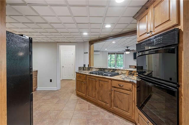 168 Eagle Pointe Dr, Dahlonega, GA 30533 - kitchen featuring black appliances, light tile patterned floors, baseboards, recessed lighting, and brown cabinets