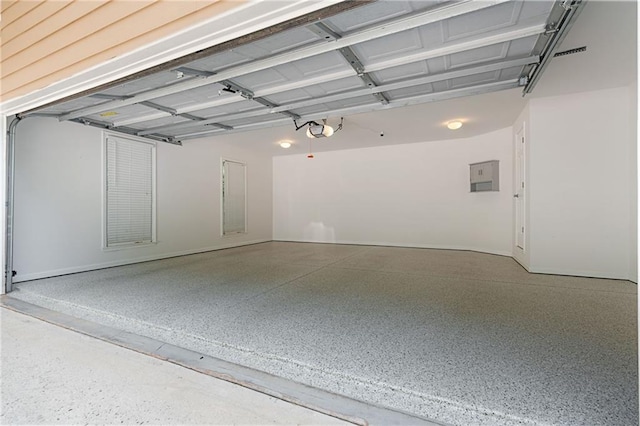 168 Eagle Pointe Dr, Dahlonega, GA 30533 - garage featuring electric panel, a garage door opener, and baseboards