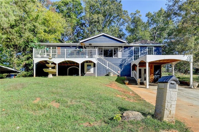 view of front of house with a wooden deck, a carport, and a front lawn