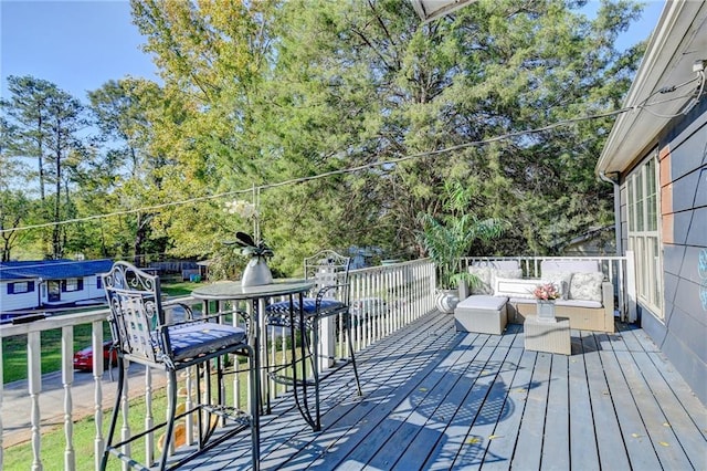 wooden deck featuring outdoor lounge area