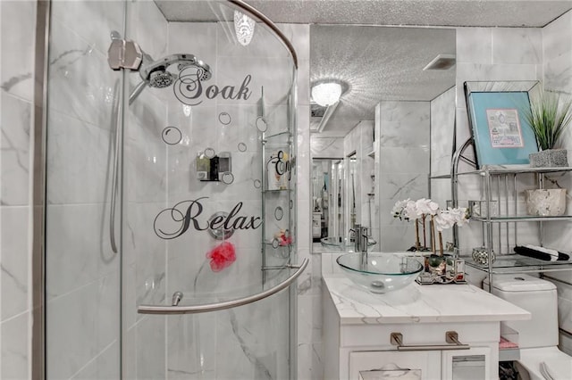 bathroom featuring vanity, a textured ceiling, toilet, and walk in shower