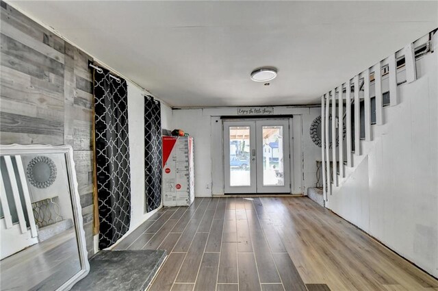 foyer entrance featuring hardwood / wood-style floors and french doors