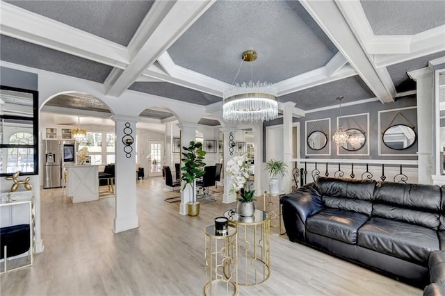 living room featuring beamed ceiling, coffered ceiling, ornate columns, and light hardwood / wood-style floors