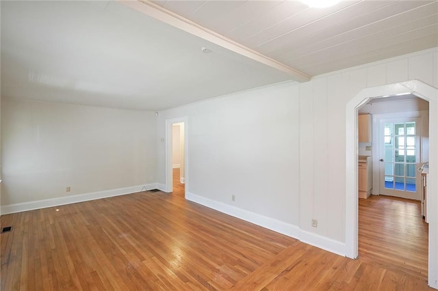 2055 Anderson Dr SE, Smyrna, GA 30080 - empty room featuring light wood-type flooring, arched walkways, and baseboards