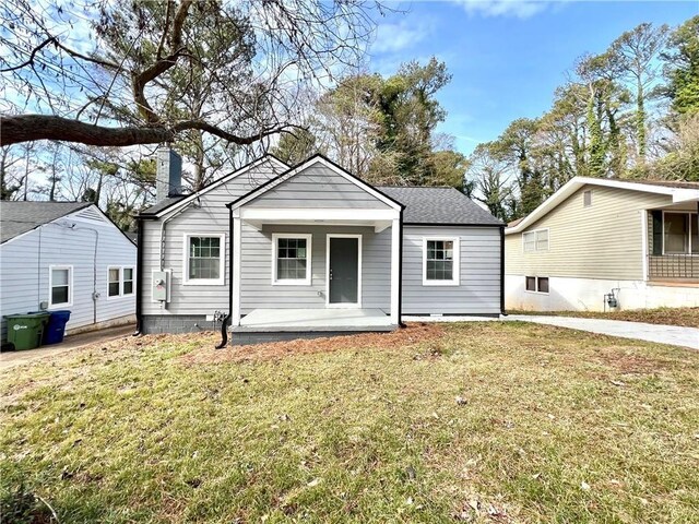 1271 Lorenzo Dr SW, Atlanta, GA 30310 - view of front of property with covered porch, a front yard, a chimney, and roof with shingles