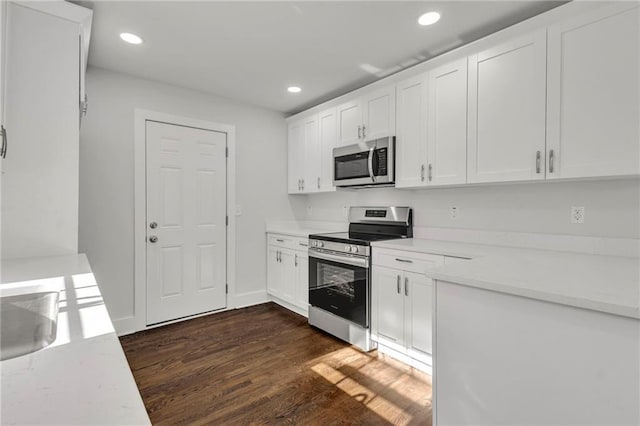 1271 Lorenzo Dr SW, Atlanta, GA 30310 - kitchen with appliances with stainless steel finishes, recessed lighting, light countertops, white cabinets, and dark wood-type flooring