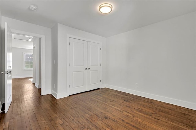 1271 Lorenzo Dr SW, Atlanta, GA 30310 - unfurnished bedroom featuring dark wood-style flooring, baseboards, attic access, and a closet