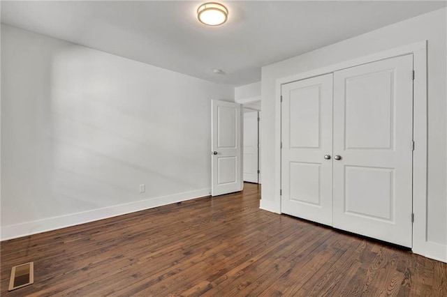 1271 Lorenzo Dr SW, Atlanta, GA 30310 - unfurnished bedroom featuring dark wood-type flooring, baseboards, and a closet
