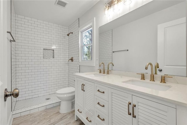 1271 Lorenzo Dr SW, Atlanta, GA 30310 - bathroom featuring toilet, double vanity, and tiled shower