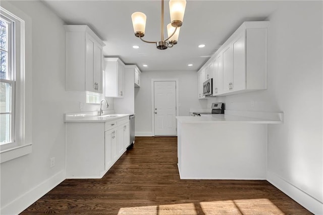 1271 Lorenzo Dr SW, Atlanta, GA 30310 - kitchen featuring stainless steel appliances, a sink, light countertops, baseboards, and recessed lighting