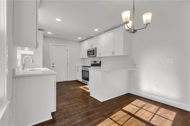 1271 Lorenzo Dr SW, Atlanta, GA 30310 - kitchen with appliances with stainless steel finishes, a sink, white cabinets, baseboards, and dark wood-style floors