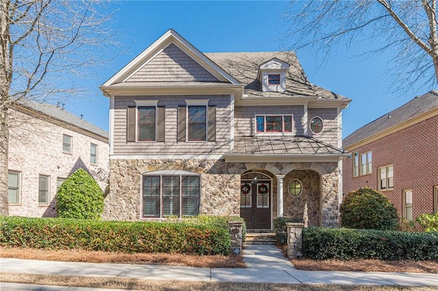 view of front of house featuring stone siding and french doors