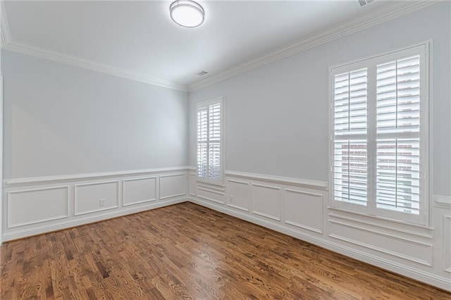 spare room with hardwood / wood-style flooring and ornamental molding