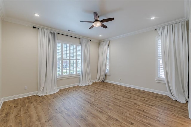 spare room with ceiling fan, ornamental molding, and light wood-type flooring