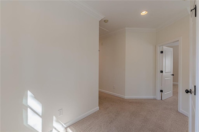 hallway featuring ornamental molding and light carpet