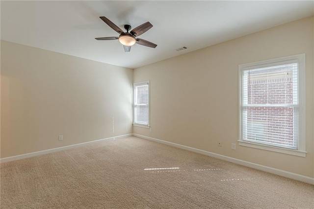 unfurnished room with carpet flooring and ceiling fan