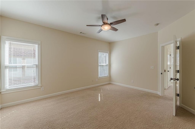 carpeted spare room with ceiling fan