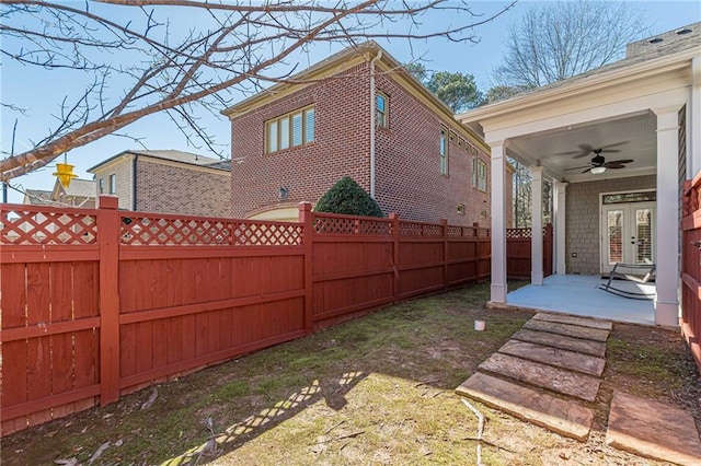 view of yard featuring a patio, french doors, and ceiling fan