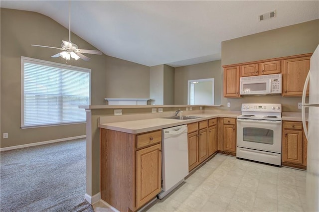 kitchen featuring kitchen peninsula, white appliances, lofted ceiling, and sink