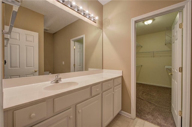 bathroom with vanity and a textured ceiling