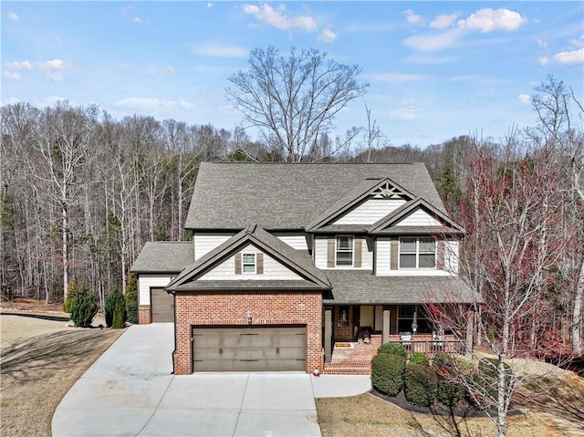 view of front of home featuring driveway, covered porch, a shingled roof, and brick siding