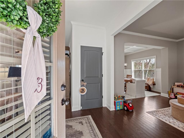 entryway featuring baseboards, ornamental molding, and dark wood-style flooring