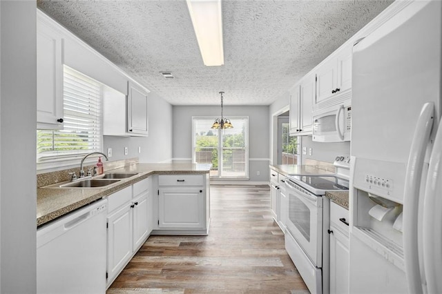 630 River Mill Rd, Bethlehem, GA 30620 - kitchen featuring white appliances, a peninsula, light wood-type flooring, a textured ceiling, and white cabinets