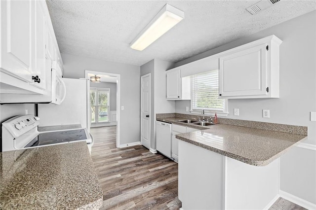 630 River Mill Rd, Bethlehem, GA 30620 - kitchen with white appliances, a sink, a peninsula, wood finished floors, and a textured ceiling