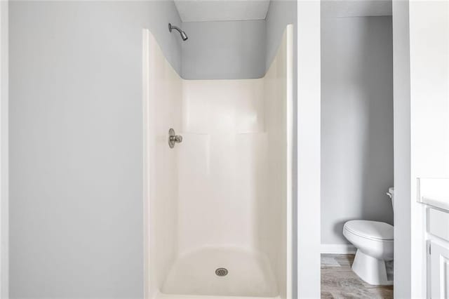630 River Mill Rd, Bethlehem, GA 30620 - bathroom featuring a textured ceiling, toilet, a shower, vanity, and wood finished floors