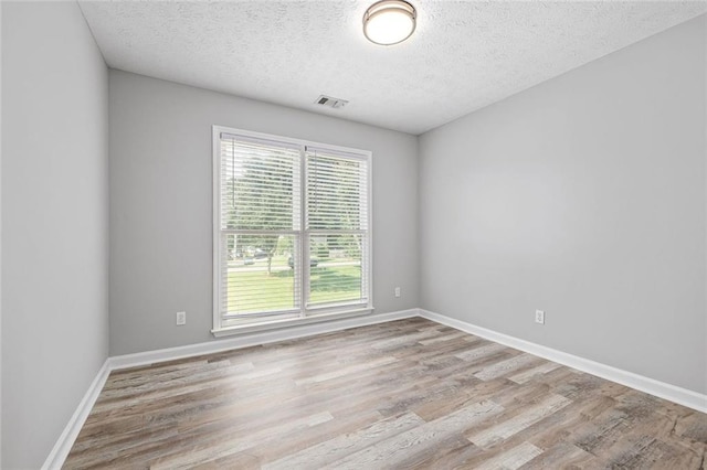 630 River Mill Rd, Bethlehem, GA 30620 - spare room with a textured ceiling, wood finished floors, and baseboards