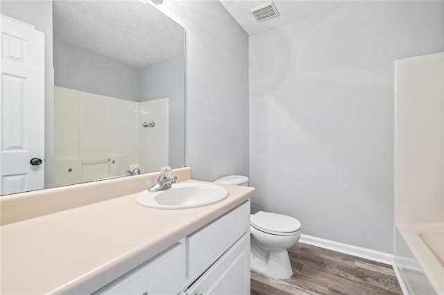 630 River Mill Rd, Bethlehem, GA 30620 - bathroom featuring a textured ceiling, wood finished floors, vanity, toilet, and baseboards