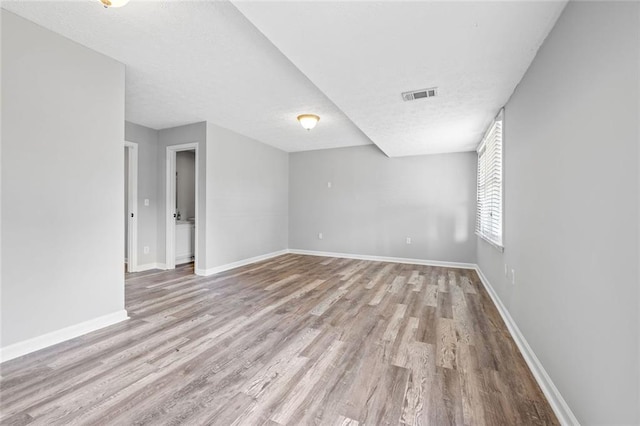 630 River Mill Rd, Bethlehem, GA 30620 - unfurnished room featuring wood finished floors, baseboards, and a textured ceiling