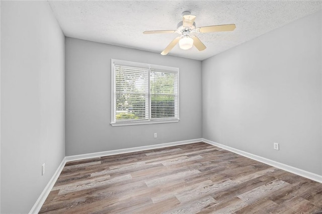 630 River Mill Rd, Bethlehem, GA 30620 - spare room with a textured ceiling, wood finished floors, a ceiling fan, and baseboards