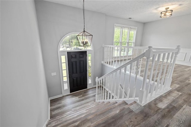 630 River Mill Rd, Bethlehem, GA 30620 - foyer entrance featuring wood finished floors, a textured ceiling, and a chandelier