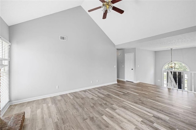 630 River Mill Rd, Bethlehem, GA 30620 - unfurnished living room featuring high vaulted ceiling, ceiling fan, wood finished floors, and baseboards