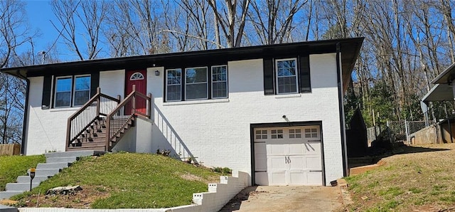 view of front of home with concrete driveway, a garage, brick siding, and a front lawn