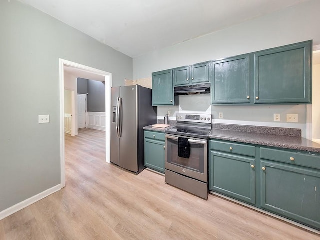 388 Oakhaven Way, Villa Rica, GA 30180 - kitchen with stainless steel appliances, under cabinet range hood, dark countertops, light wood-style floors, and wainscoting