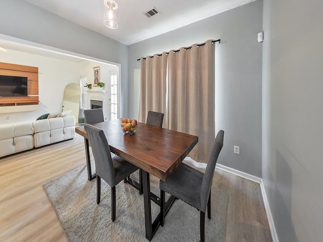 388 Oakhaven Way, Villa Rica, GA 30180 - dining space with baseboards, visible vents, arched walkways, and wood finished floors