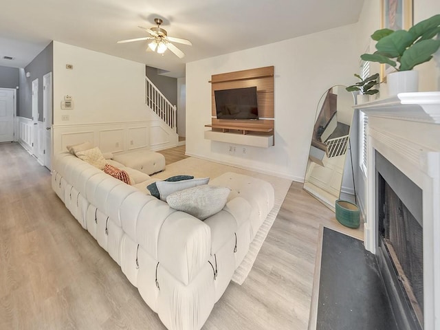 388 Oakhaven Way, Villa Rica, GA 30180 - living area with a fireplace with flush hearth, light wood-type flooring, ceiling fan, and a decorative wall