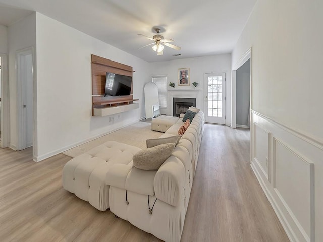 388 Oakhaven Way, Villa Rica, GA 30180 - living room with a fireplace, ceiling fan, visible vents, and light wood finished floors