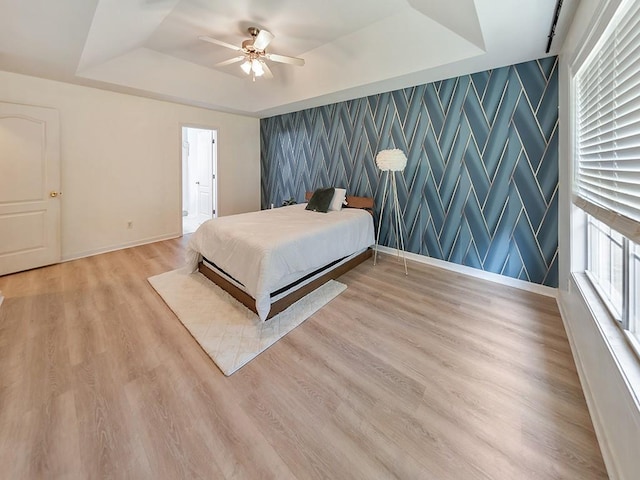 388 Oakhaven Way, Villa Rica, GA 30180 - bedroom featuring wallpapered walls, light wood-style floors, a tray ceiling, and baseboards